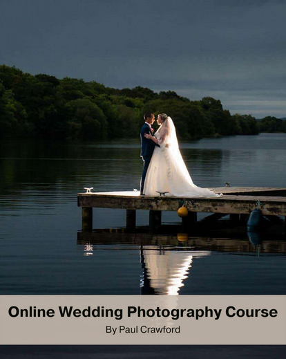 A beautiful wedding couple posing by the lake at night for wedding photoshoot
