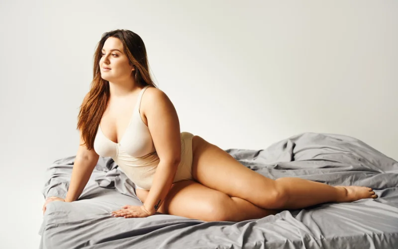 Vintage-inspired pin-up boudoir pose with playful expression and retro styling
