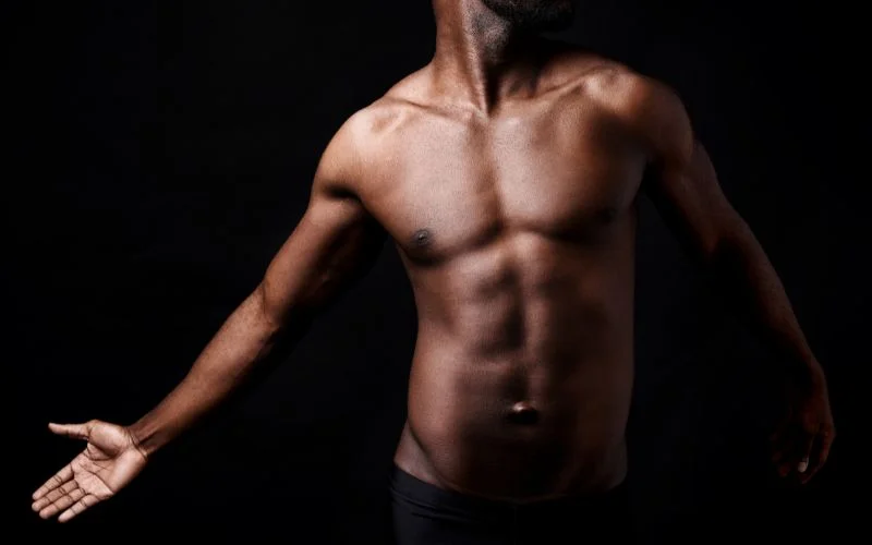 Close-up fine art male nude photography highlighting body details and texture