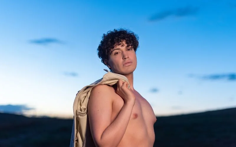 Emotional male nude portrait showcasing expressive facial features and mood