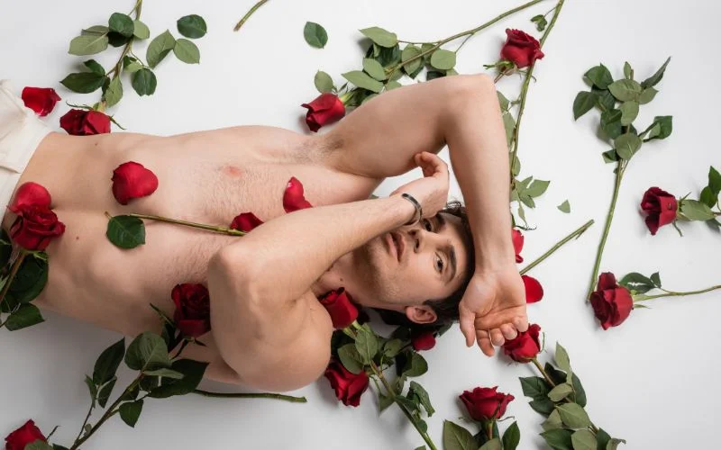 Male nude model lying down in a relaxed fine art photography pose