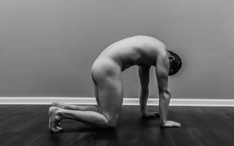 Male nude yoga pose demonstrating flexibility, balance, and body control