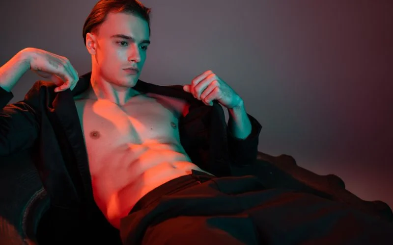 Colourful neon lighting setup used in modern men’s boudoir poses for dramatic portraits