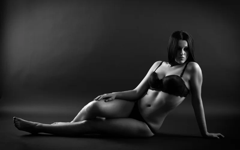 Backlit silhouette plus size nude shot against a bright window, focusing on outline over detail