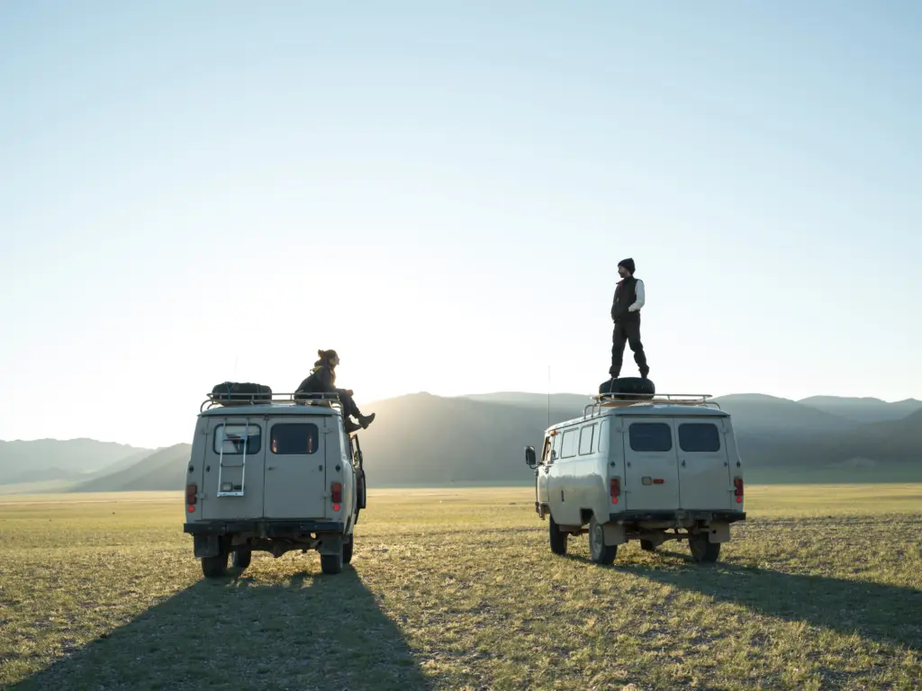 photo of people standing on a van