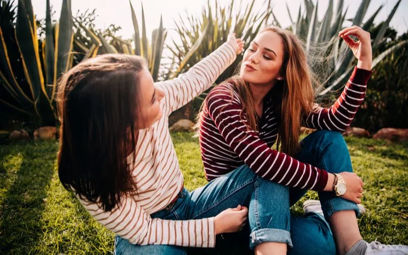 Two best friends staring into each other's eyes in a playful and expressive friend pose