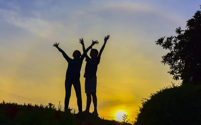 Creative shadow play best friend photoshoot pose captured in natural sunlight