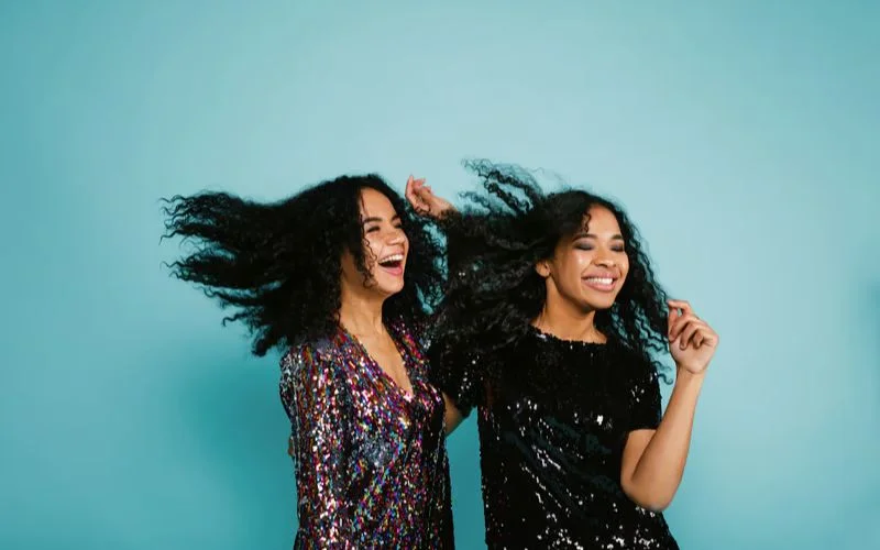 Best friends tossing their hair together in a carefree and energetic photo pose