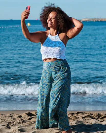 Individual capturing a full-length mirror photo that highlights outfit details and confident full body selfie poses.