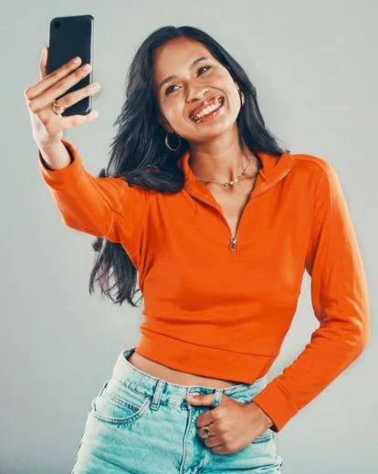 Individual posing with soft natural light illuminating their face for a flattering selfie portrait.