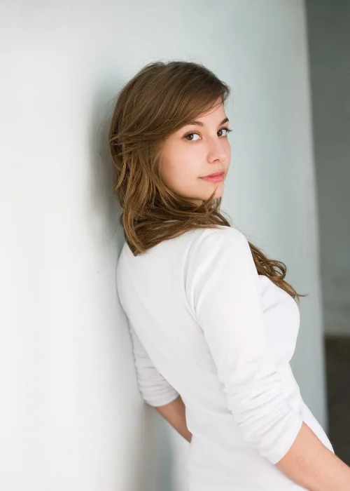 Professional headshot with a looking over the shoulder pose and natural expression.