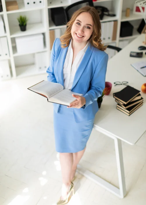 Professional headshot using props such as a laptop, notebook, or coffee mug.