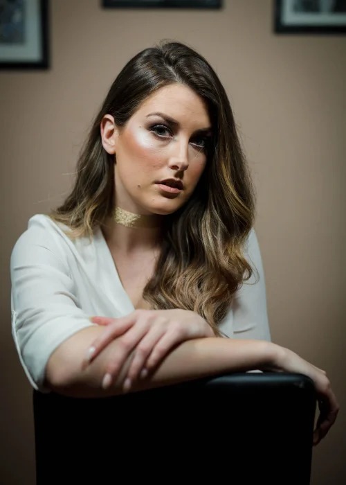 Business portrait with a leaning forward pose for a friendly and engaging look.