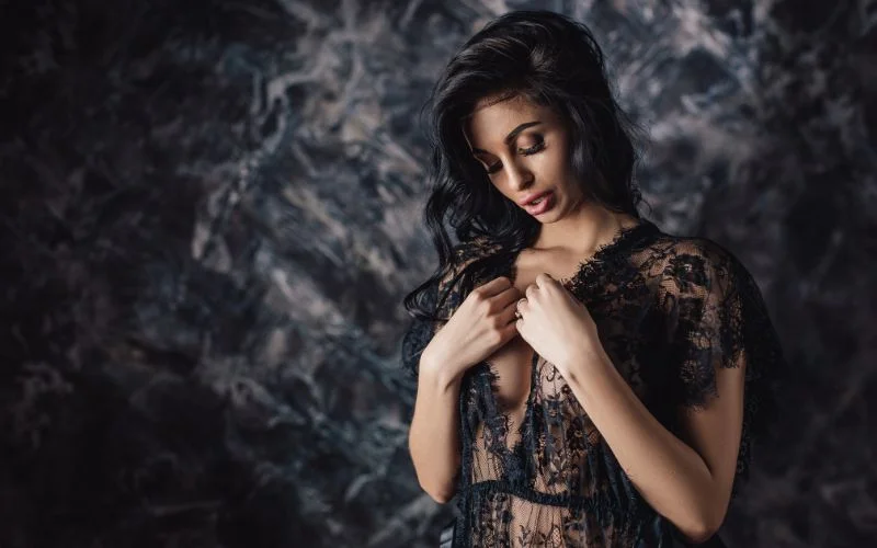 Luxury bedroom boudoir photography with glamorous styling and confident posture