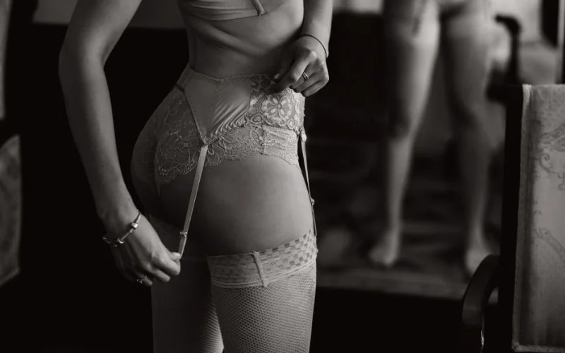 Female model posing during a luxury boudoir shoot with editorial-inspired lighting