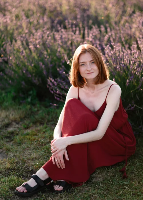 Woman in a red dress sitting among purple flowers, one of several full body portrait poses shown