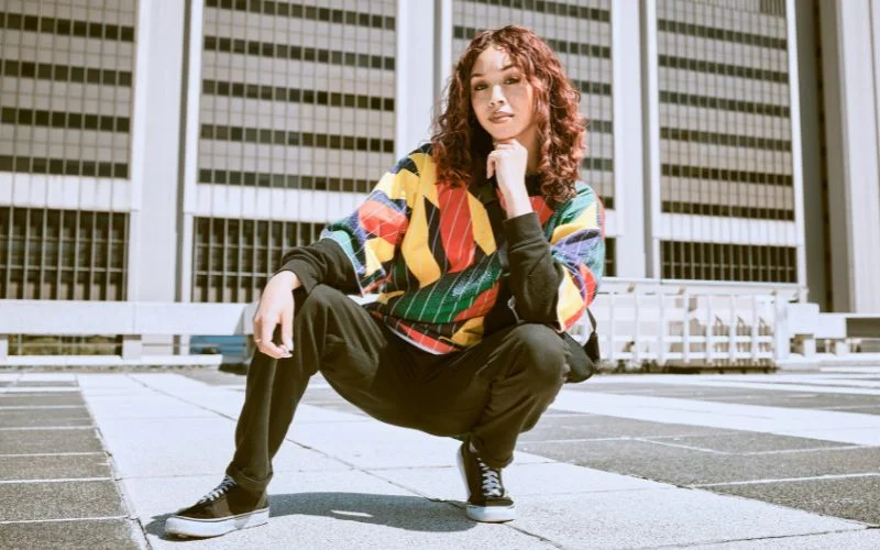 Stylish resting pose with relaxed fashion-forward body language and attitude