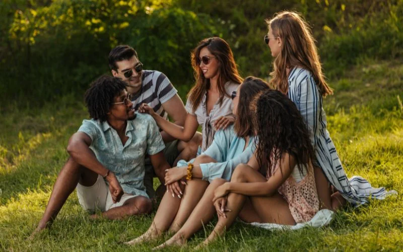 Aesthetic group portrait featuring friends sitting together in coordinated poses