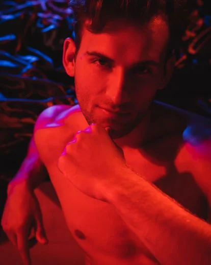 Creative men boudoir portrait featuring vibrant colors and reflective highlights