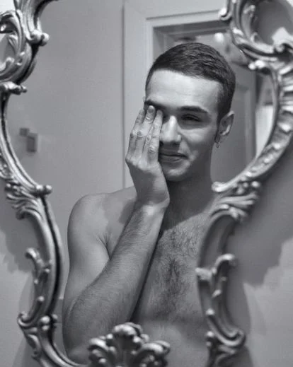 male boudoir poses selfie in front of a mirror
