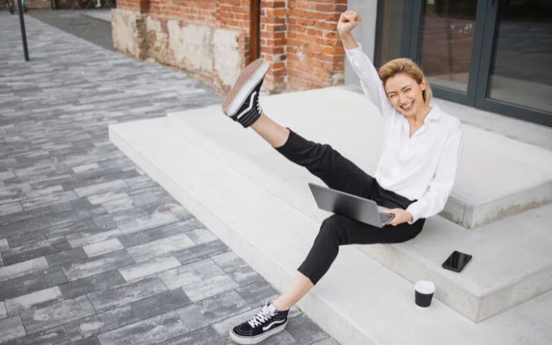 Playful portrait pose with one leg kicked in the air and energetic body movement