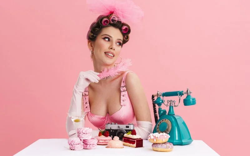 female pin up model posing playfully with a vintage telephone in a sexy pin up style