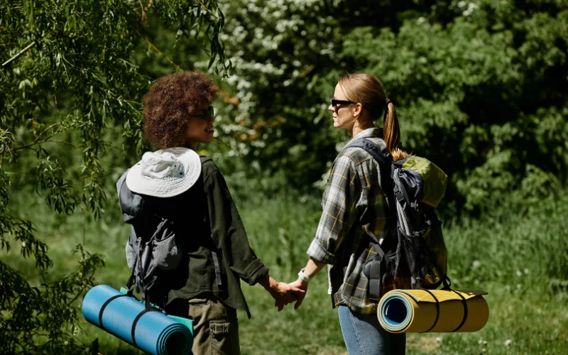 Two hikers walking side by side on a trail, creating natural and candid hiking portraits.