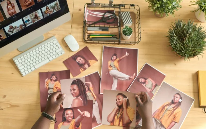 A collection of stock photos displayed on a desk showing how to sell stock photos online