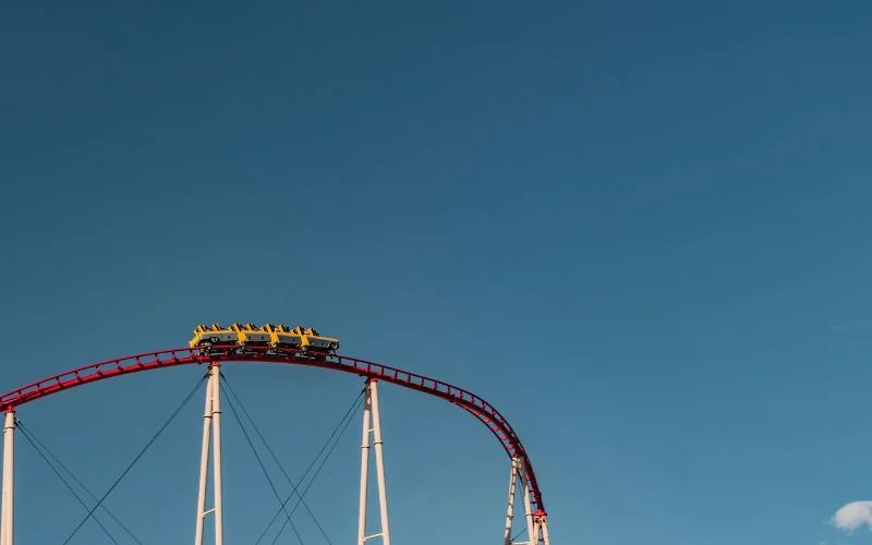 Roller coaster frozen mid-motion against a clear blue sky, an example of what a high shutter speed captures