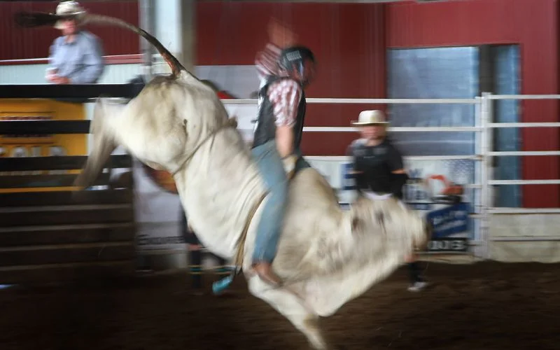Bull rider captured with slight motion blur at 1/30 sec for a dynamic, creative effect