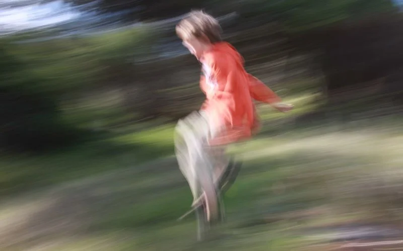 Same boy in motion at 1/8 sec shutter speed, showing deliberate motion blur instead of a frozen frame