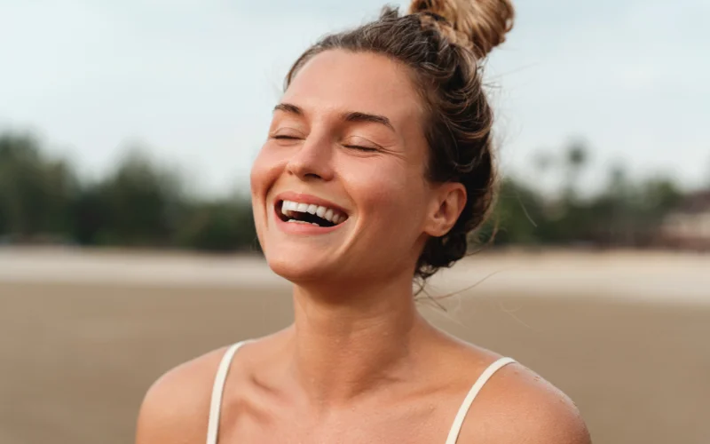 Relaxed model taking a deep breath before smiling naturally for a photo